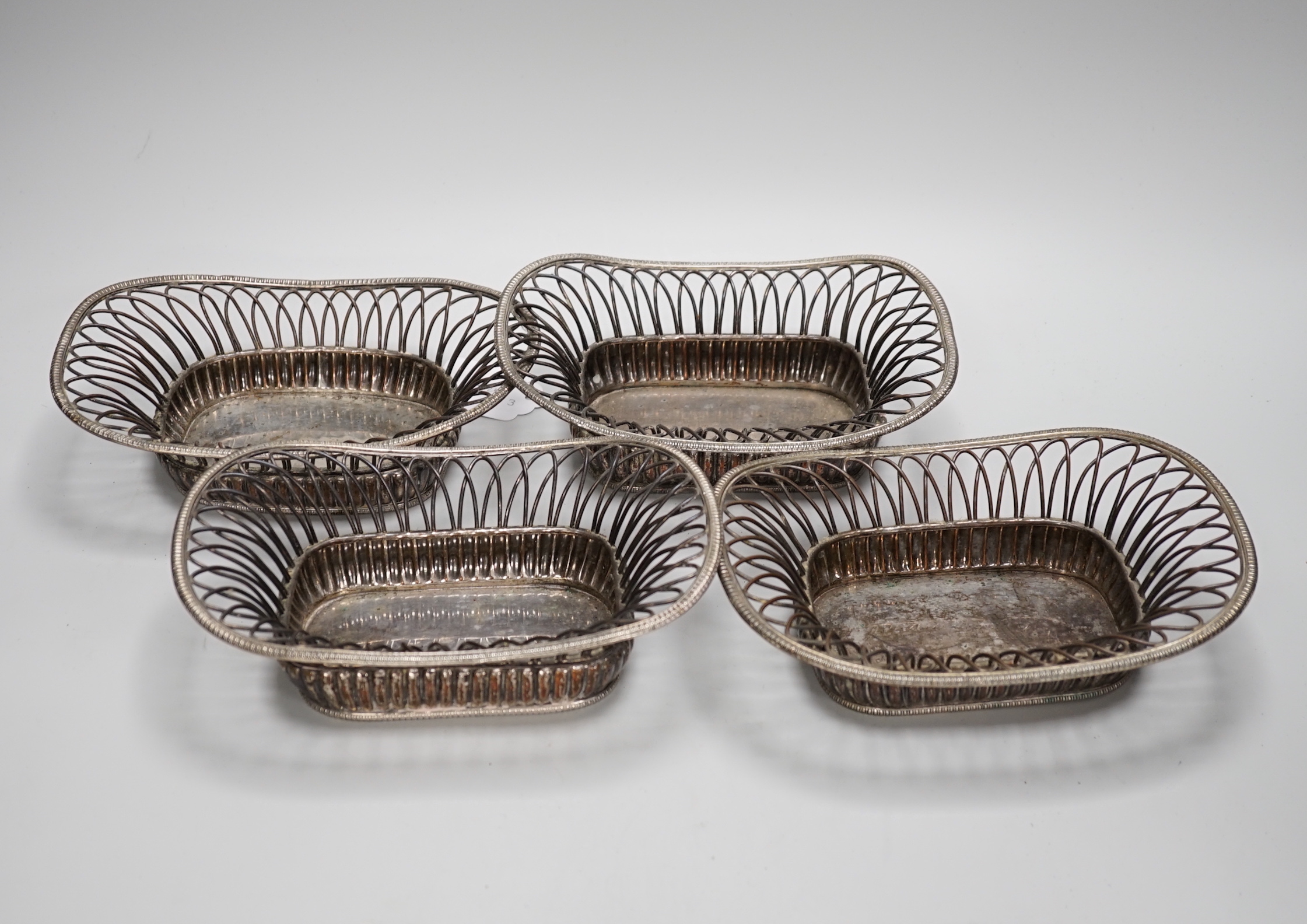 Four silver plated wire-work baskets, each 21cm wide